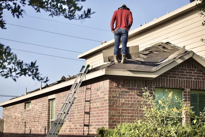 Professional roofer working on a residential roof in East Fallowfield